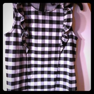 Women’s sleeveless shirt with ruffles.